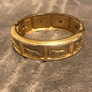 GOLD AND SILVER TONED BRACELET DISPLAYING COUGAR IMAGES.